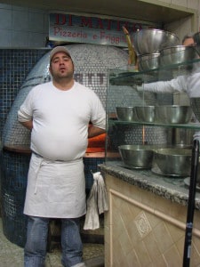 The pizzaiolo and the wood oven at Da Matteo  on Via dei Tribunali in Naples. It's located very close to the famous street Via San Gregorio Armeno known for the workshops of the creche artisans. 