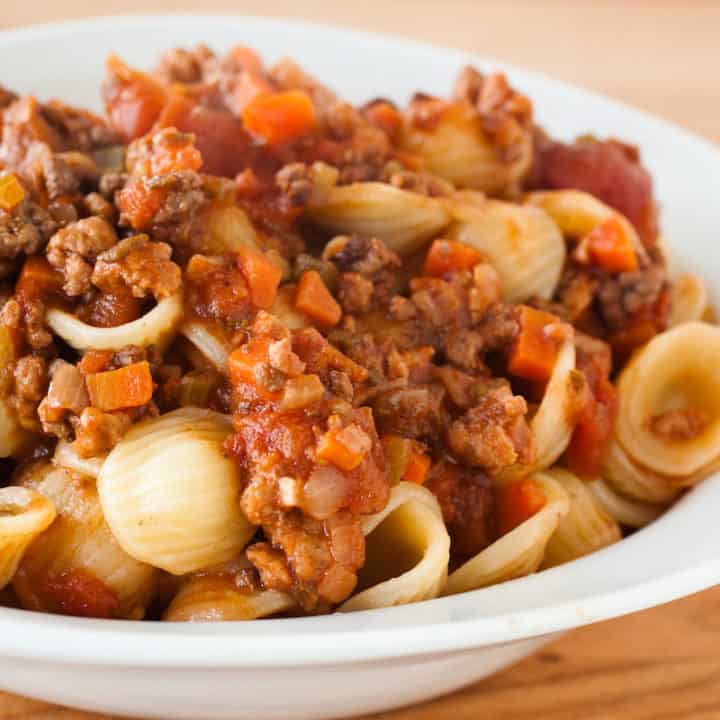 Meaty Italian Bolognese sauce doesn't have to take all day to make; grab a second pan and you'll have it done in 2 hours. #bolognese #italian