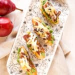 tartines topped with arugula, bacon, pears, dates, and cheese