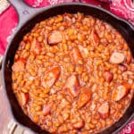 franks and beans in a cast iron skillet