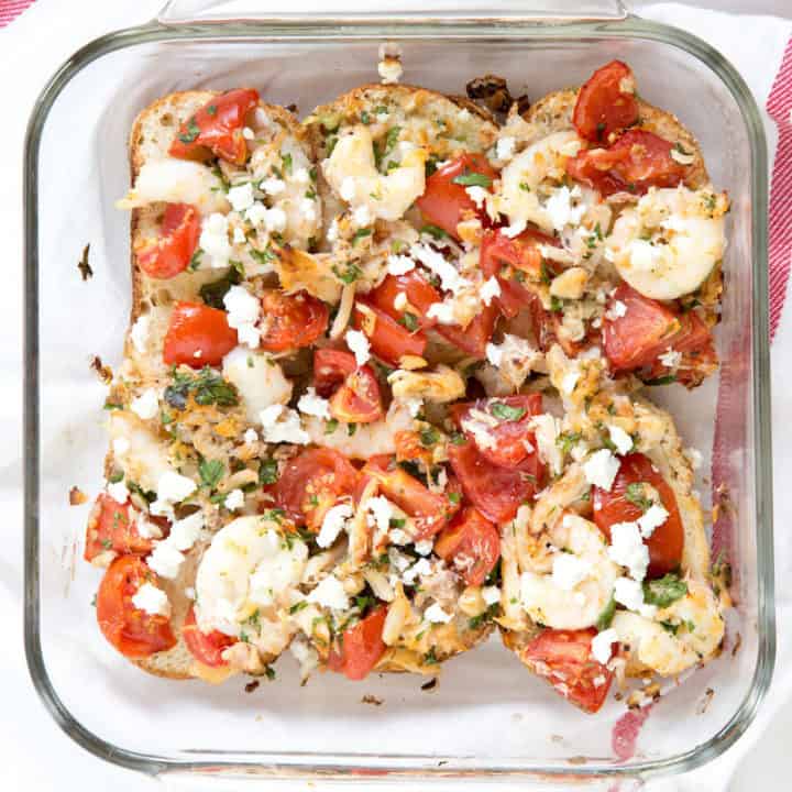 Roasted shrimp, tomato, and feta bruschetta go from a handheld appetizer into a hearty weeknight family meal.
