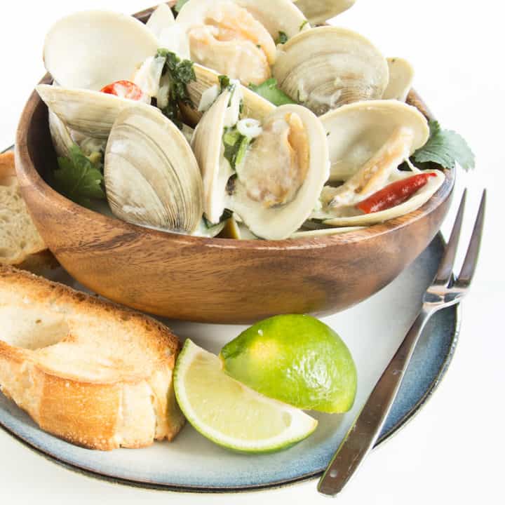 Thai coconut clams simmered in a curry-inspired broth are a whole new kind of comfort food. Serve with crusty bread or rice noodles for a quick meal.